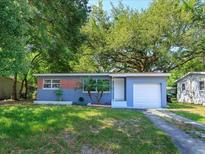 Charming single-story home with mature trees and a well-maintained front yard at 3524 Amigos Ave, Orlando, FL 32808