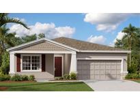Beautiful single-story home with neutral paint, shutters, a nicely landscaped yard, and a two-car garage at 4317 Riverbend Blvd, Haines City, FL 33844