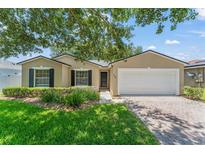 Charming single-story home with manicured lawn, brick driveway, and attached two-car garage at 476 Basking Ridge Ct, Ocoee, FL 34761