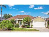 Charming single-story home with well-manicured lawn, mature landscaping, and two car garage at 529 Quail Down Dr, Debary, FL 32713