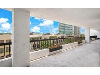 This balcony features decorative flower boxes and an open view to the exterior landscaping at 530 E Central Blvd # 406, Orlando, FL 32801