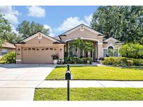 Charming single-Gathering home featuring a manicured lawn, mature trees, and a two-car garage at 533 Pickfair Ter, Lake Mary, FL 32746