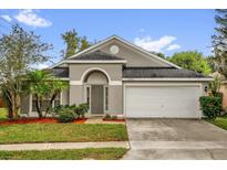 Charming single-story home featuring a manicured lawn, two-car garage and an inviting front entrance at 10930 Buckwater Ct, Orlando, FL 32817