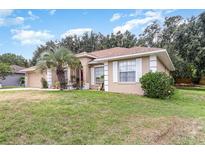 Charming single-story home with a well-maintained lawn and inviting curb appeal at 11512 Clair Pl, Clermont, FL 34711