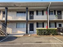 Charming two-story condo with black shutters, a balcony, and a well-maintained exterior at 1250 S Denning Dr # 108, Winter Park, FL 32789