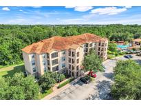 Stunning condo building featuring a terracotta roof with lush surroundings and convenient parking at 1375 Tuscana Ln # 1102, Davenport, FL 33896