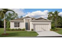 Well-maintained single-story home with a two-car garage, manicured lawn, and lush landscaping at 2234 Crown Rock Dr, Haines City, FL 33844