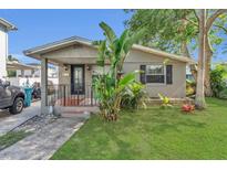 Charming single-story home featuring a cozy front porch and lush green lawn at 232 E Grant St, Orlando, FL 32806