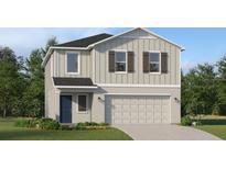 Two-story home with light gray vertical siding, dark gray shutters, and a two car garage at 3531 Kimbrough Dr, Lake Wales, FL 33859