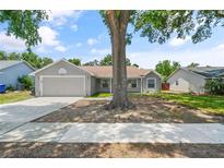 Charming single-story home features a well-maintained front yard and attached two-car garage at 5160 Wood Ridge Ct, Ocoee, FL 34761