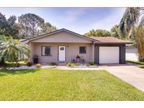 Charming single-story home with well-maintained lawn, landscaping, and a one car garage at 5216 Sunrise Blvd, Orlando, FL 32803