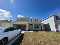Charming two-story home featuring an attached garage and a well-manicured front yard at 5350 Pine Lilly Dr, St Cloud, FL 34771