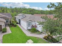 Charming single-story home featuring manicured landscaping and a welcoming walkway leading to the front entrance at 636 Grand Canal Dr, Kissimmee, FL 34759