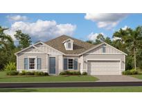 Charming one-story home with neutral siding, blue shutters and a well-manicured lawn at 809 Tundra Loop, Groveland, FL 34736
