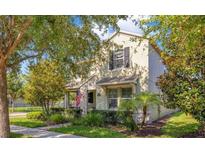 Charming two-story home with a well-maintained lawn and lush landscaping, creating curb appeal at 8256 Bayview Crossing Dr, Winter Garden, FL 34787