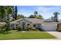 Charming single-story home featuring manicured lawn and inviting covered entryway at 1107 Almond Tree Cir, Orlando, FL 32835