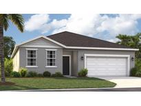 Charming single-Gathering home with gray stucco, a two-car garage, and a well-manicured lawn at 1267 Normandy Dr, Haines City, FL 33844