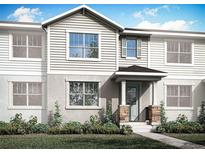 Charming two-story townhouse with stone accents and inviting front porch at 1323 Tarflower Dr, Winter Springs, FL 32708