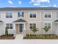 Charming townhome featuring stone accents, a covered entryway, and tidy landscaping at 1323 Tarflower Dr, Winter Springs, FL 32708