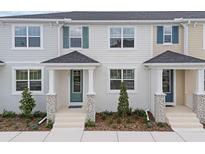 Charming townhouse featuring a cozy front porch and well-manicured landscaping, enhancing curb appeal at 1327 Tarflower Dr, Winter Springs, FL 32708