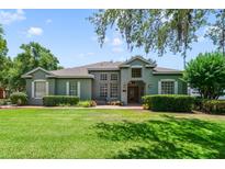 Charming single-story home with lush front lawn and attractive landscaping under a cloudy sky at 1515 Cherry Lake Way, Lake Mary, FL 32746
