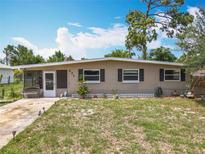 Charming single-story home with a well-manicured lawn and a screened-in porch, offering a cozy curb appeal at 221 Golden Days Dr, Casselberry, FL 32707