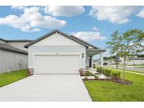 Charming single-Gathering home featuring a two-car garage, well-manicured lawn, and welcoming front porch at 2502 Linda Knoll Ln, Bartow, FL 33830