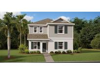 Charming two-story home with green shutters, a stone walkway, and lush landscaping on a bright, sunny day at 3009 Namaste Dr, Clermont, FL 34714