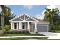 Charming single-story home featuring stone accents, gray siding and a well manicured lawn at 5733 Haystack Drive, St Cloud, FL 34771