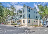 Attractive three-story building with balconies, blue shutters and a street view at 611 Campus St # 160, Celebration, FL 34747