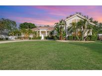 Charming home features a lush lawn, tropical landscaping, and a welcoming entrance at 6121 Oxbow Bend Ln, Port Orange, FL 32128