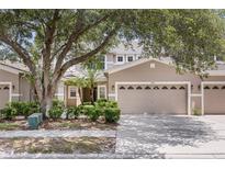 Charming townhome featuring a neutral color scheme, a two-car garage, and lush landscaping in a well-maintained community at 1062 Wickerwood St, Ocoee, FL 34761