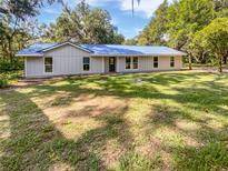 Charming single-story home featuring a new blue metal roof and verdant lawn at 13794 Sw 112Th St, Dunnellon, FL 34432