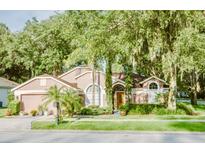 Charming single-Gathering home with lush landscaping and mature trees at 2102 Applegate Dr, Ocoee, FL 34761