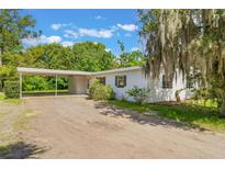 Charming single-story home features a carport and a spacious yard, offering comfort and convenience in a serene setting at 212 Homewood Dr, Sanford, FL 32773