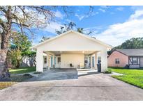 Charming single-story home showcasing a covered carport with a spacious concrete driveway at 2417 Cedar Ave, Sanford, FL 32771