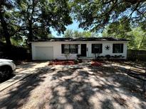 Charming single story home with a well-maintained front yard and a one car garage at 25824 Shawnee St, Sorrento, FL 32776