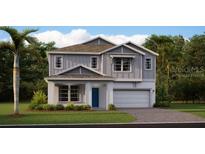 Charming two-story home with a well-manicured lawn and attached two car garage at 2871 Haze Rd, Clermont, FL 34714