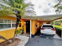 Charming yellow home featuring a carport, well-manicured landscaping, and inviting curb appeal at 3130 S Bumby Ave # S, Orlando, FL 32806