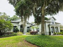 Charming single-Gathering home with mature landscaping, green lawn, and moss-draped trees at 635 Whitman Cv, Longwood, FL 32750