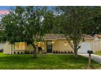 Charming single-story home with well-maintained lawn and mature trees in a tranquil setting at 10849 William Tell Dr, Orlando, FL 32821