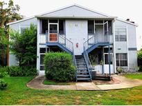 Well-maintained condo with stairs leading to the front door and surrounding greenery at 1108 Northlake Dr # 1108, Sanford, FL 32773