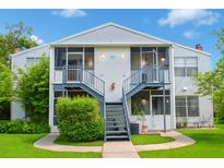 Inviting two-story exterior showcasing well-maintained landscaping and screened-in patios, perfect for relaxing outdoors at 1108 Northlake Dr # 1108, Sanford, FL 32773