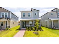 Charming two-story home featuring a welcoming porch and beautiful landscaping at 12259 Bracco St, Winter Garden, FL 34787