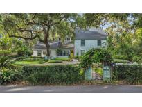 Charming two-story home with mature trees, lush landscaping, and a welcoming yellow front door at 1315 E 24Th St, Sanford, FL 32771