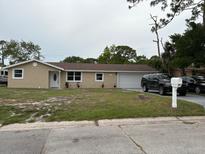 Charming single-story home featuring a well-maintained lawn and attached garage at 1516 Culverhouse Dr, Daytona Beach, FL 32117