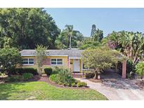 Charming single story home with beautiful landscaping, brick driveway and walkway on a sunny day at 2810 Nancy St, Orlando, FL 32806