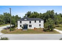 Charming two-story home with a well-manicured lawn and beautiful landscaping at 309 N Kepler Rd, Deland, FL 32724