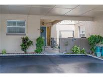 Inviting condo entrance with covered parking, lovely landscaping, and a charming blue door at 314 Windmeadows St # 314, Altamonte Springs, FL 32701