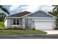 Charming single-story home featuring a two-car garage, stone accents, and neatly landscaped front yard at 3569 Dahlia Dr, Lake Hamilton, FL 33851